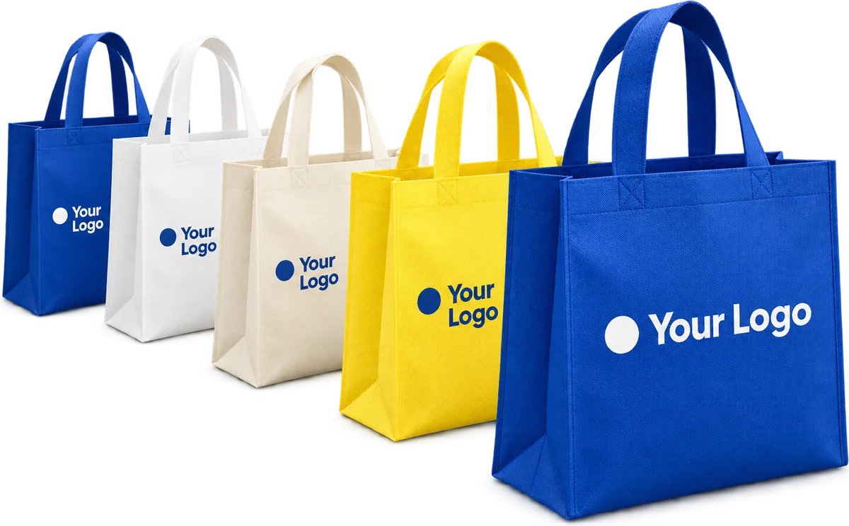 Plain custom non woven tote bags in royal blue, lemon yellow, cream and white, standing in a row
